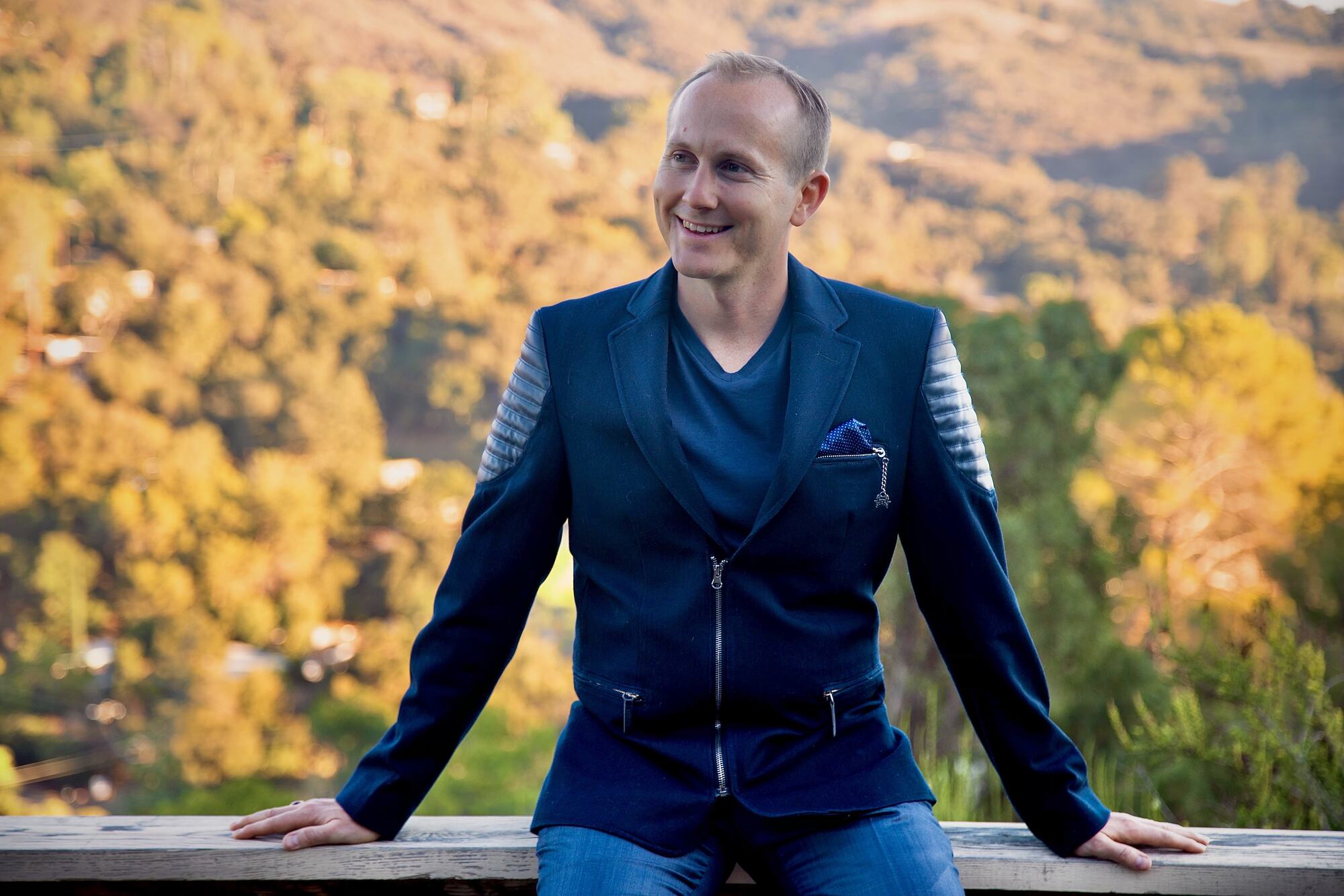 Clifton Smith seated outdoors above the Topanga hills at golden hour